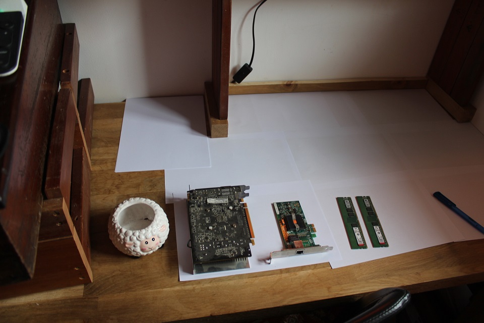 a collection of computer components on paper sheets on my desk